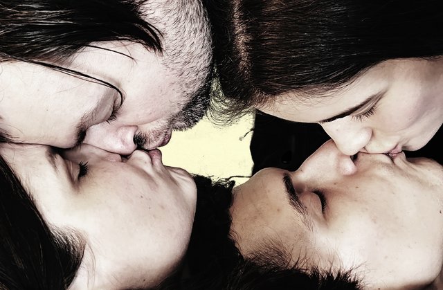 Two couples kissing